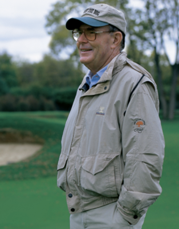 Pete Dye, Golf Course Architect, shown standing on a golf course.